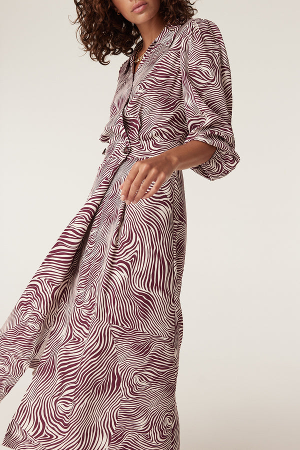 Anouk zebra print midi dress in burgundy and cream, featuring a collared neckline and flowy skirt.