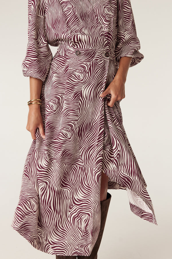 Anouk zebra print midi dress in burgundy and cream, featuring a wrap style, button detail, and balloon sleeves.