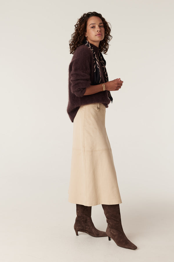 Natural Ines faux suede midi skirt with button details, worn by a model.