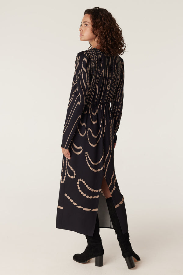 Navy camel spot Margaux dress with long sleeves, high neck, and elegant draped chain pattern.