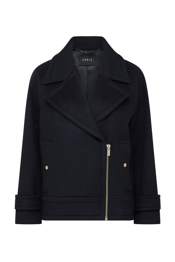 Navy wool Roy jacket with an asymmetrical gold zipper, wide lapels, and gold button details.