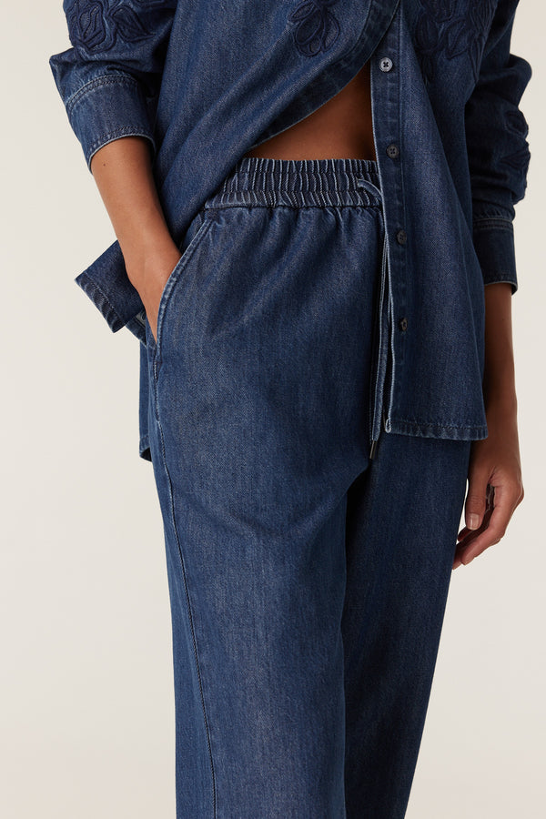 Indigo Essie denim jogger pants with elastic waist and matching embroidered denim shirt.