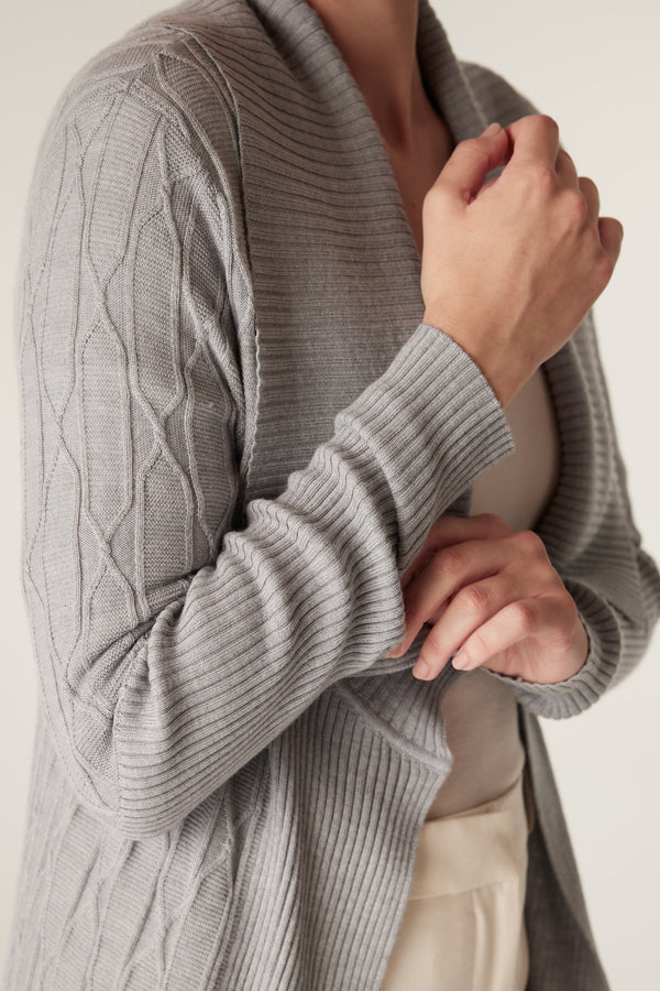 Grey marle merino wool cardigan with cable knit sleeves and ribbed collar, worn by a model.