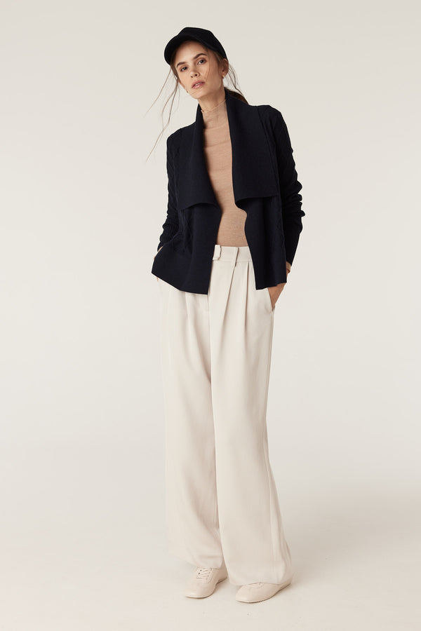 Model wears The Elizabeth Midnight Navy Merino Cardigan with diamond cable stitching and Milano collar.