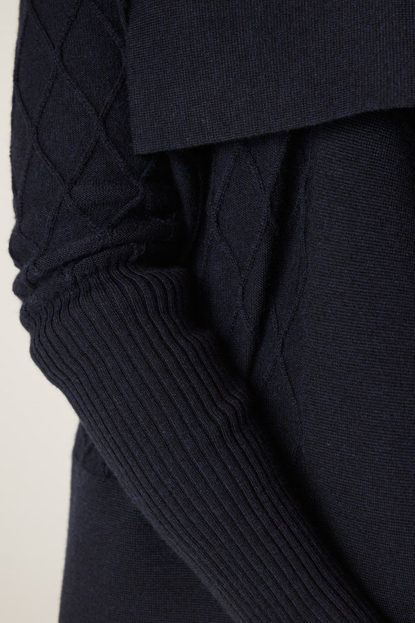 Midnight navy Merino wool cardigan with diamond cable stitching and ribbed sleeve cuff.