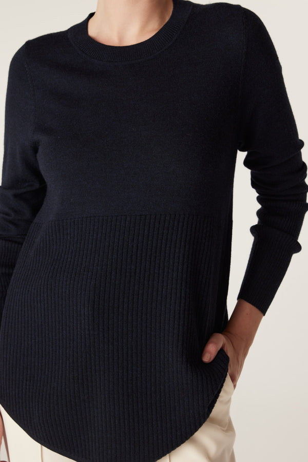 Midnight navy merino wool jumper with a crew neck, ribbed lower panel, and curved hem.