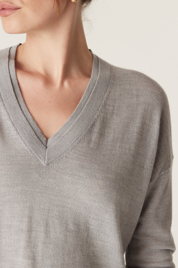 Grey marle fine merino wool V-neck jumper with double collar trim and dropped shoulder.