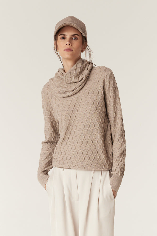 Pebble Merino wool snood with diamond cable knit, worn by a model with a matching cap.