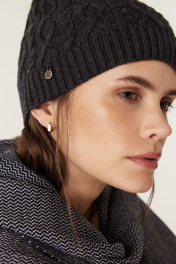 Charcoal Merino wool beanie with diamond cable knit, ribbed hem, and gold Heritage branded plate.