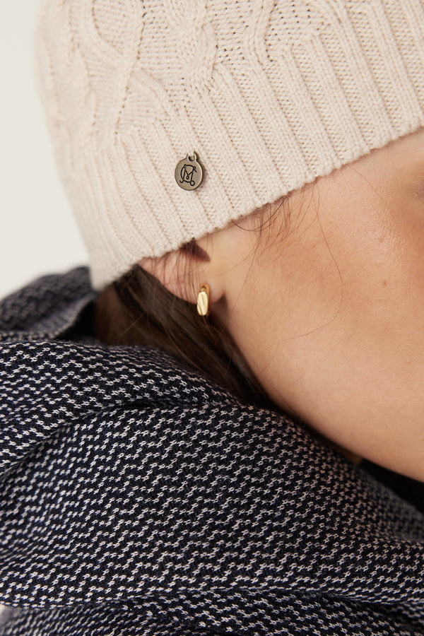 Oatmeal Merino wool beanie with diamond cable knit, ribbed hem, and Heritage branded plate.