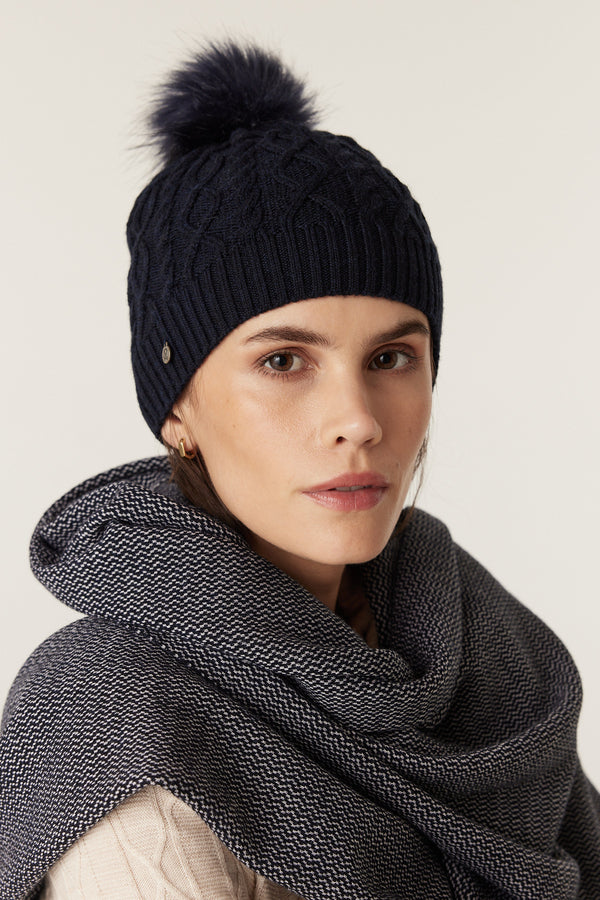 Midnight Navy Merino beanie with diamond cable knit, faux fur pom pom, and Heritage branded plate.