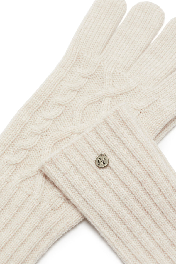 Oatmeal Merino wool gloves with diamond cable knit, ribbed cuffs, and a silver Heritage branded plate.