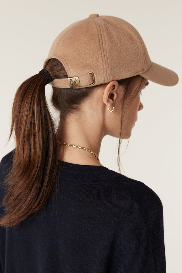 Camel wool cashmere 6-panel cap with adjustable back strap and gold slider hardware on a model.