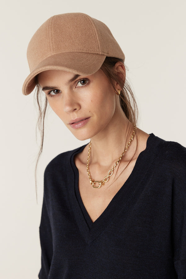 Camel wool cashmere 6-panel cap with a 7cm peak on a model.