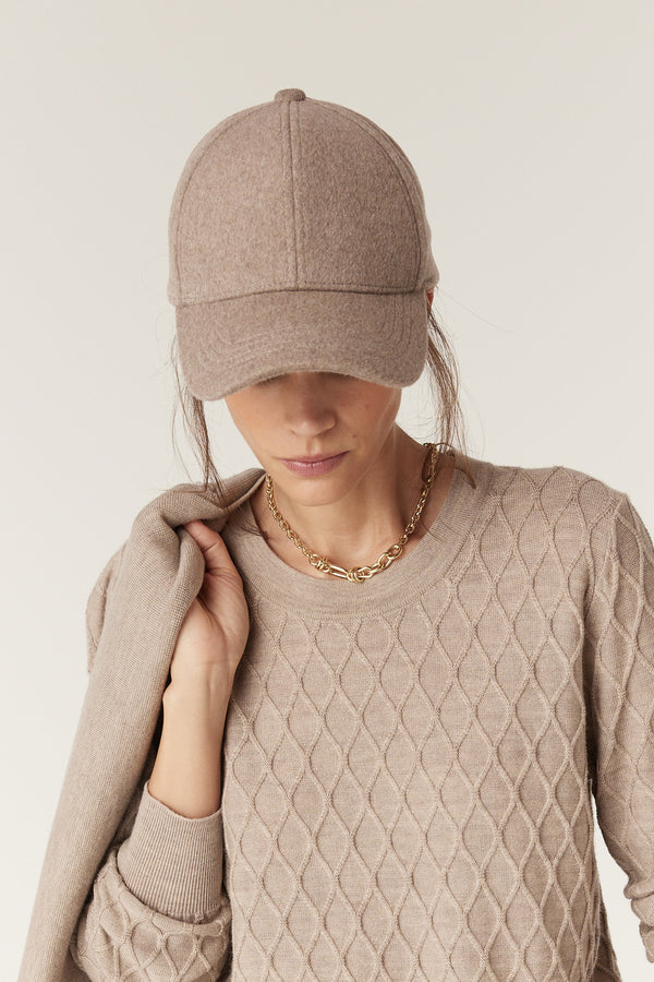 Pebble wool cashmere 6-panel cap with a 7cm peak, worn by a person in a matching sweater.