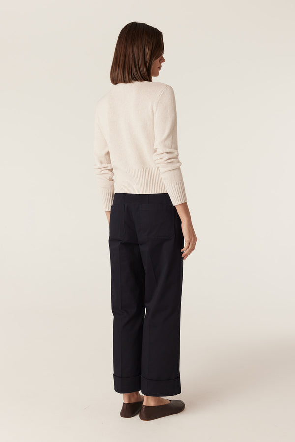 Back view of a calico cotton-linen blend V-neck cardigan featuring long sleeves and deep ribbed hem and cuffs.
