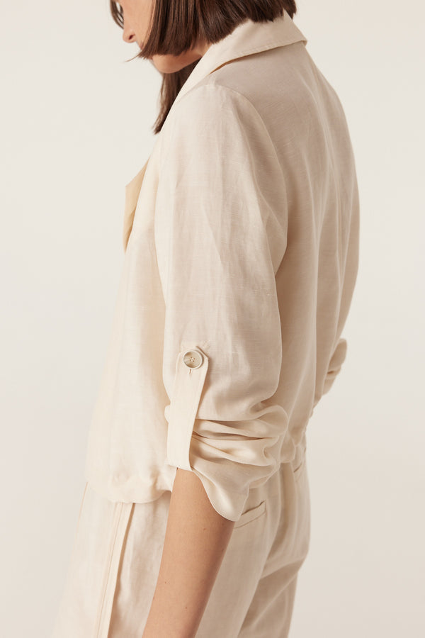 Relaxed-fit ecru Goldie jacket with a collared neckline and roll-up sleeve tabs.