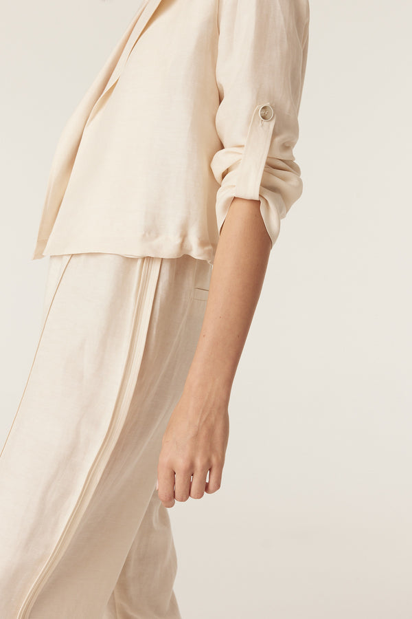 Ecru wide-leg pants paired with a matching jacket in a medium-weight, fluid fabric against a neutral background.