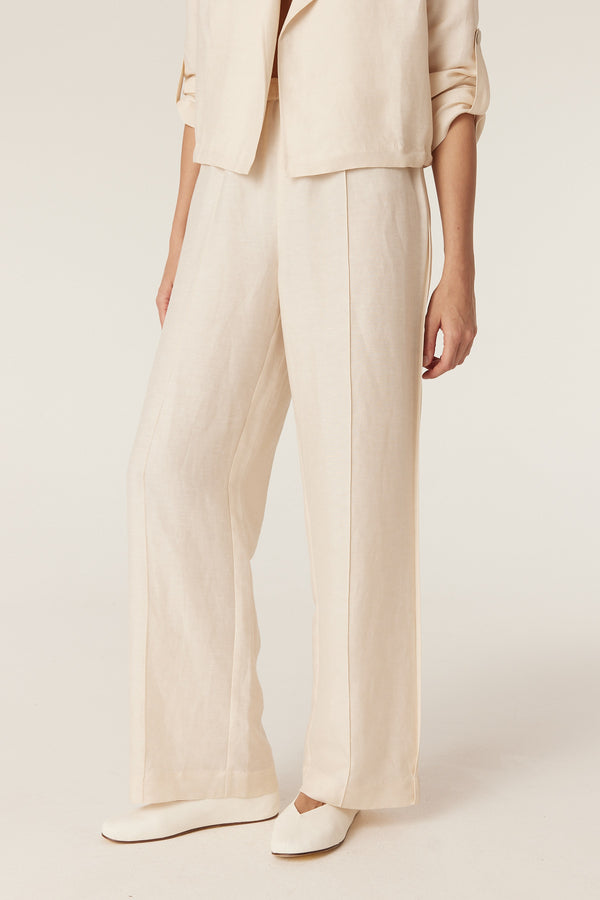 Ecru wide-leg pants in a medium-weight fabric with a clean, fluid silhouette and full-length fit.