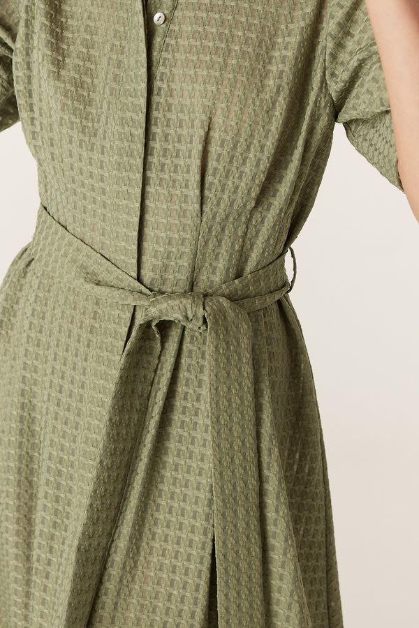 Olive midi dress in textured burnout fabric featuring a button-through front and a matching tie waist belt.