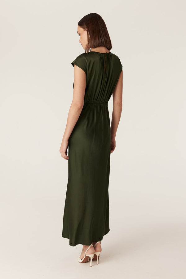 Dark green Muse dress in fluid stretch fabric with cap sleeves, gathered bodice, and a bias-cut midi skirt.