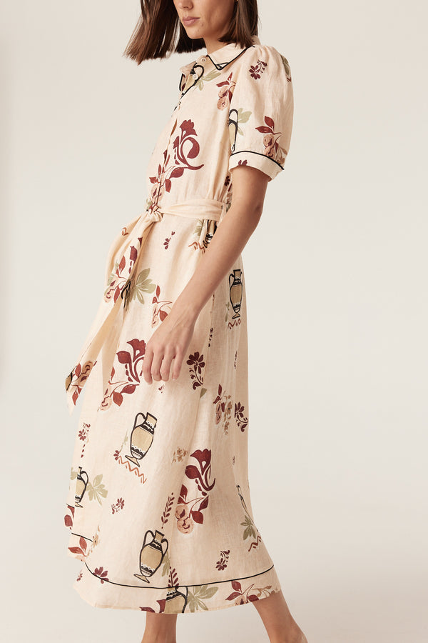 Avondale linen midi dress in rustic garden print with a button-front, tie belt, and contrast piping detail.