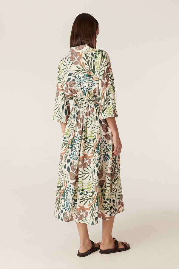 Back view of Olivia midi dress in cream with a green and brown garden print, featuring an elasticated waist and 3/4 sleeves.