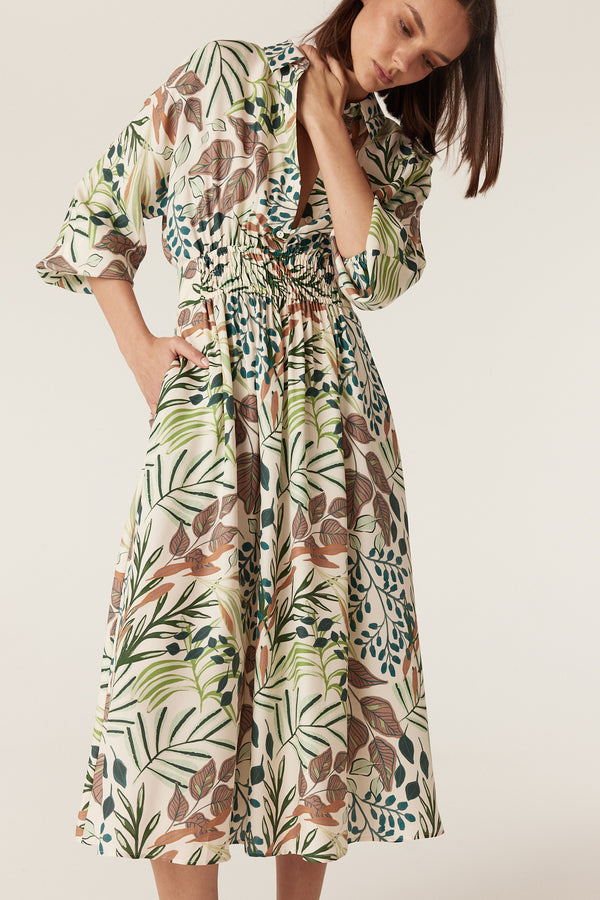 Olivia midi dress in a cream silk blend with a green and brown botanical garden print, featuring an elasticated waist.