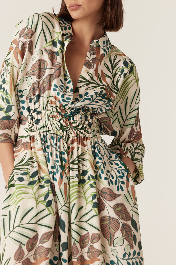 Olivia midi dress in a cream silk blend with a green and brown garden leaf print, collared neck, and elastic waist.