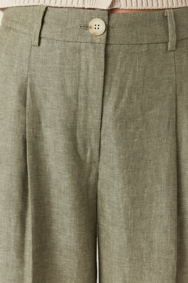 Green wide-leg pants in pure French linen featuring front pleats, belt loops, and a button-fly closure.