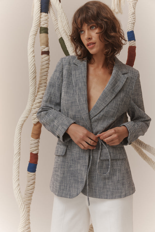 Navy marle tailored blazer with notched lapels, shoulder pads, and a matching tie waist belt.