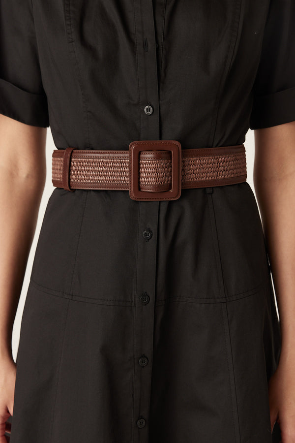 Chocolate brown genuine leather waist belt featuring a woven insert and a matching square buckle worn over a black dress.