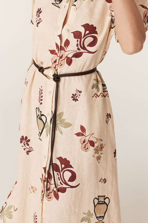 Chocolate brown Venetian leather belt featuring a sculptural gold-tone buckle worn over a floral linen dress.
