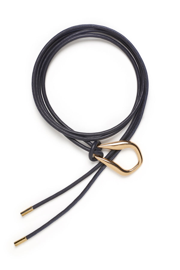 Navy Venetian leather belt with a sculptural gold-tone buckle and adjustable cord design on a white background.